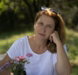 a-woman-sitting-at-a-table-with-a-vase-of-flowers.jpg a woman sitting at a table with a vase of flowers