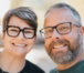 a-smiling-couple-wearing-glasses-outdoors.jpg A smiling couple wearing glasses outdoors